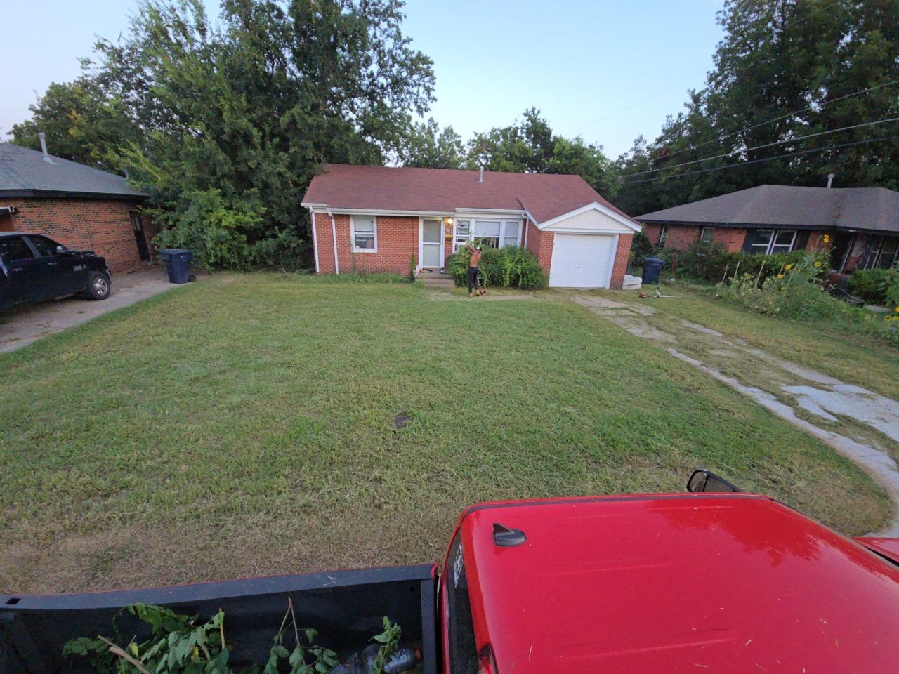 After: front yard and driveway area cut down and cleaned up by Perry Landscaping