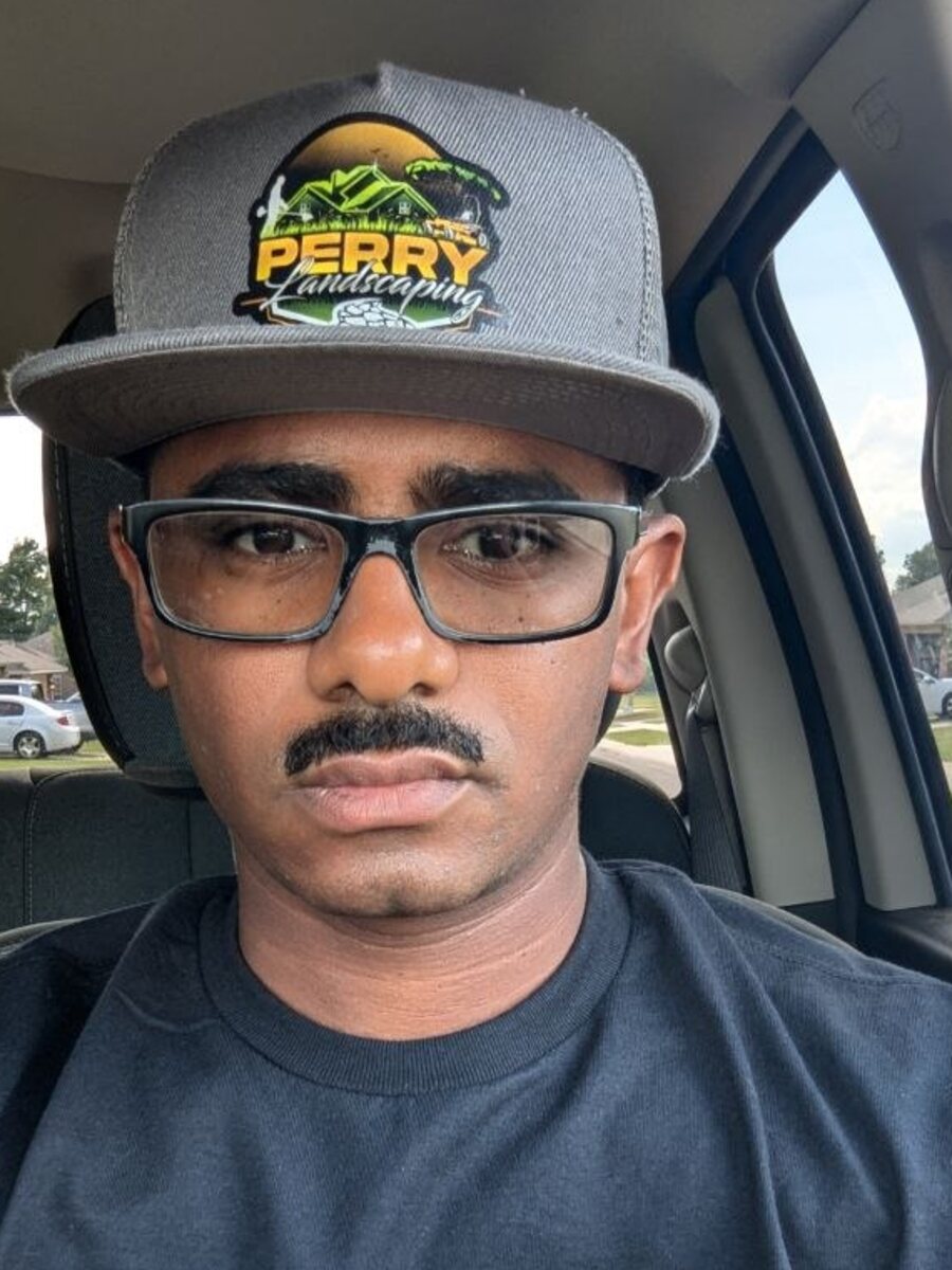 Owner of Perry Landscaping wearing a branded Perry Landscaping hat