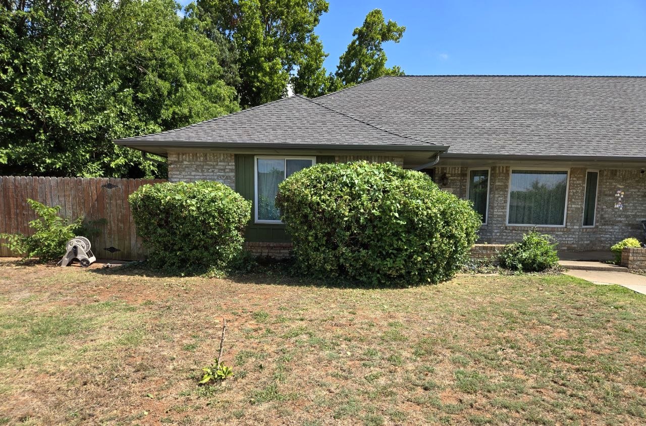 Finished side view of shaped front shrubs and cleaned-up yard